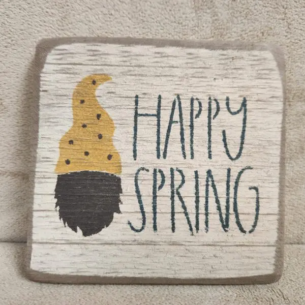 A cozy fabric square with a gnome and 'Happy Spring' text.