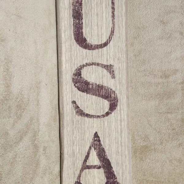 Close-up of fabric with 'USA' embroidered in purple.