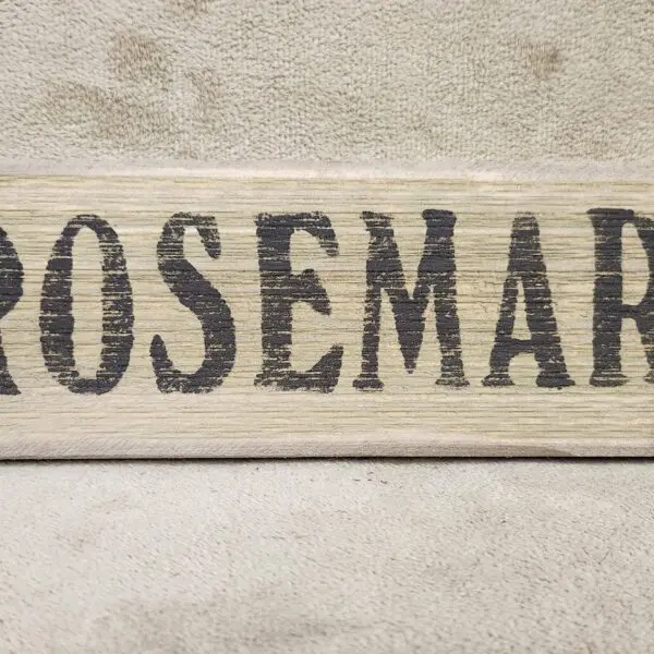 A close-up of a fabric label with the word 'ROSEMAR' printed in bold black letters.