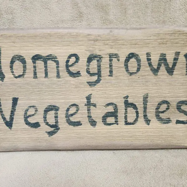 A rustic sign that reads 'Homegrown Vegetables.'