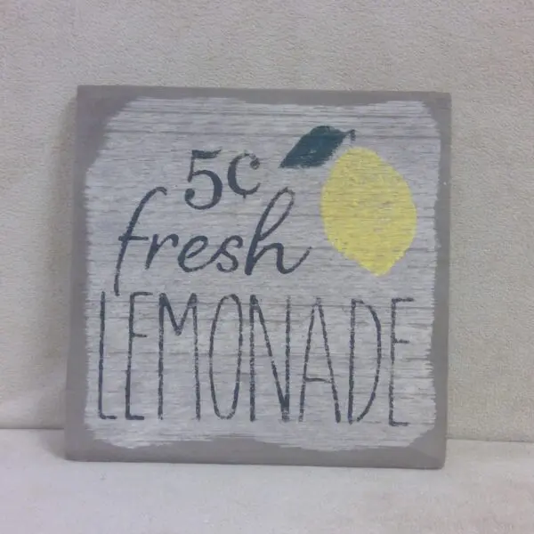 Rustic sign advertising 5 cent fresh lemonade with a lemon illustration.