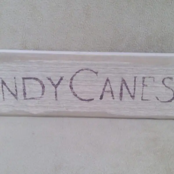 Handwritten "CANDY CANES" on a white surface.