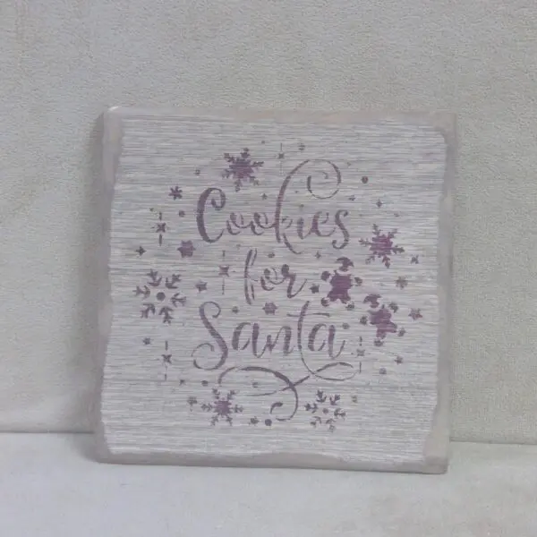 Decorative sign with 'Cookies for Santa' in festive script and stars.