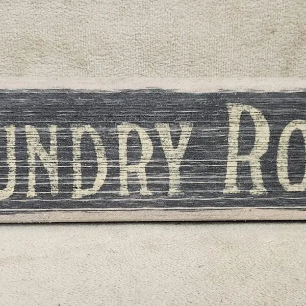 Rustic wooden sign reading 'Laundry Room'.