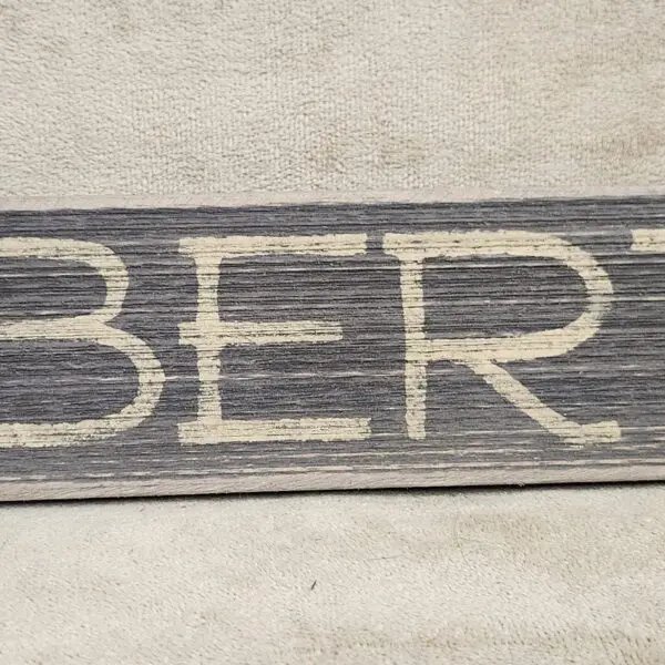 Wooden sign with the word 'LIBERTY' painted in white.