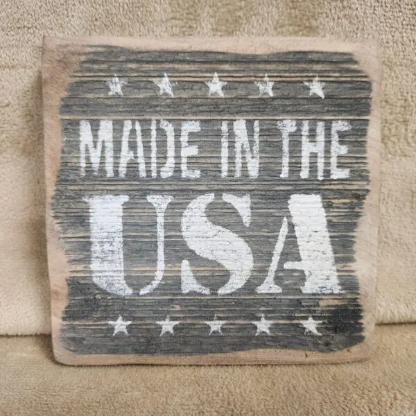 Rustic wooden sign reading 'Made in the USA' with stars.