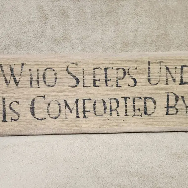 Wooden sign with comforting message about sleep and comfort.