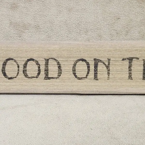 A wooden sign with the text 'WOOD ON T'.