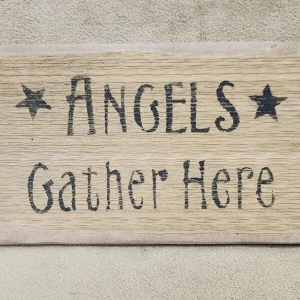 Wooden sign saying 'ANGELS Gather Here' with stars.