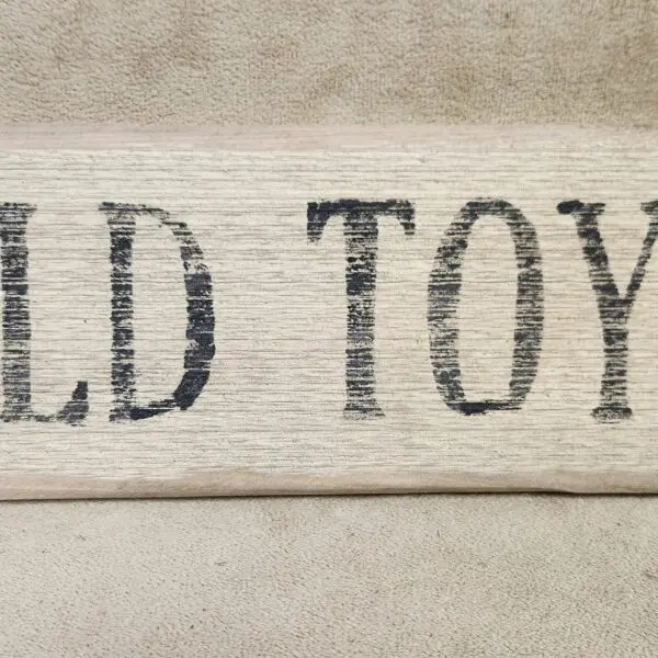 A wooden sign with the text 'OLD TOYS'.