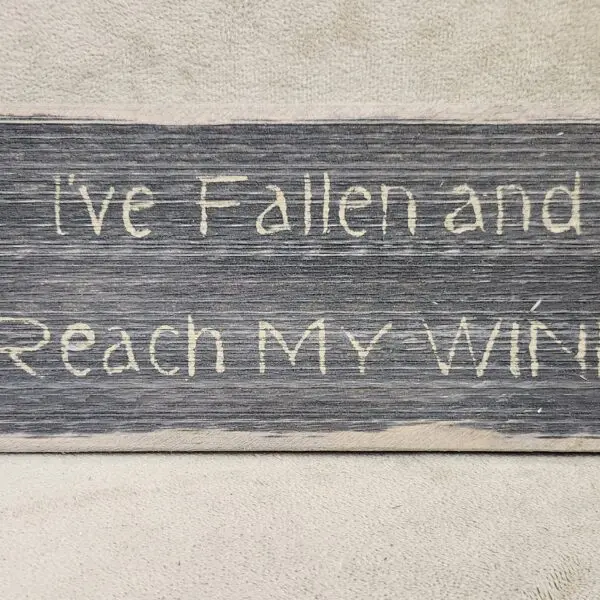 Rustic wooden sign with the quote, "I've Fallen and I Reach My Will."